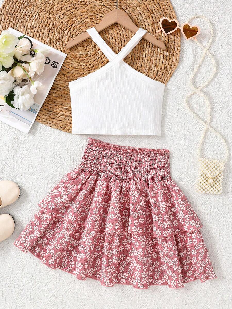 Tween girls blue and white 2-piece set with a striped halter neck vest top and a floral high-waist tiered paperbag skirt.