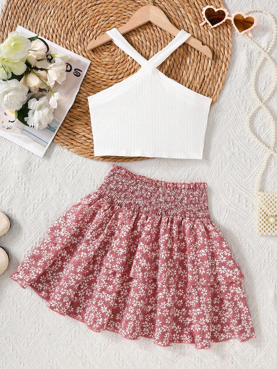 Tween girls blue and white 2-piece set with a striped halter neck vest top and a floral high-waist tiered paperbag skirt.