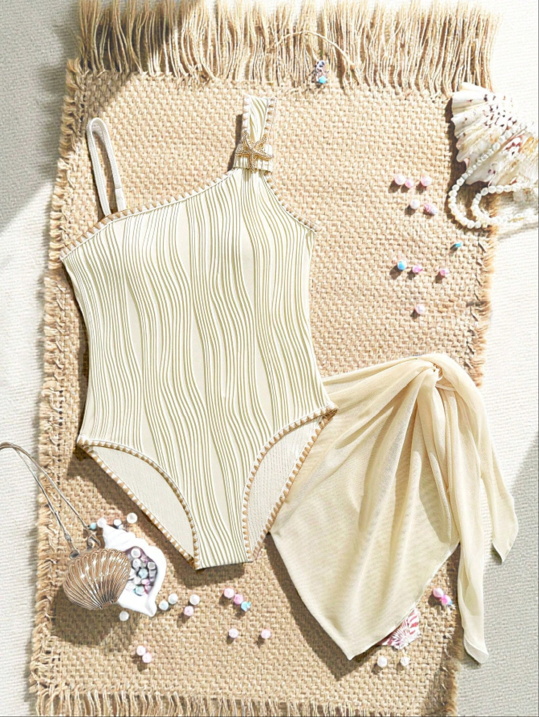 Apricot tween girls one-piece swimsuit with asymmetrical neckline, sleeveless cut, graphic starfish accents, and side-tie short sarong skirt for beach vacations