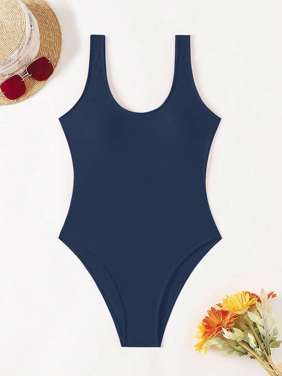 Women's solid color one-piece swimsuit featuring a backless scoop neck design and high cut fit