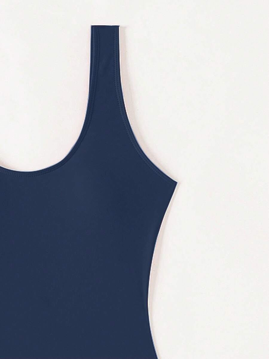 Women's solid color one-piece swimsuit featuring a backless scoop neck design and high cut fit