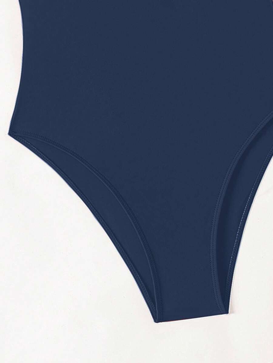 Women's solid color one-piece swimsuit featuring a backless scoop neck design and high cut fit