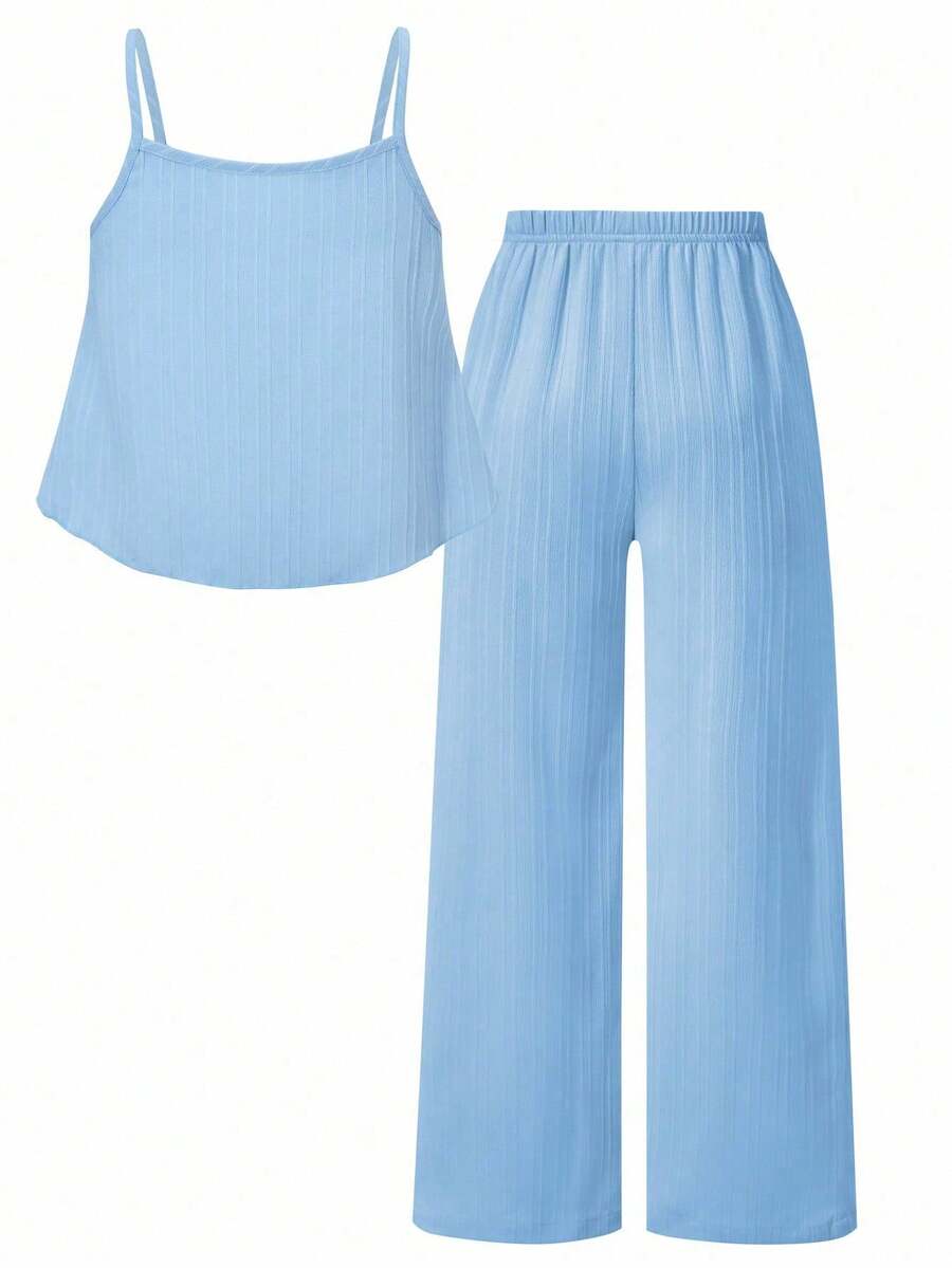 Tween girl wearing an apricot 2-piece outfit set featuring a shirred spaghetti strap short cami top and matching wide-leg long pants.