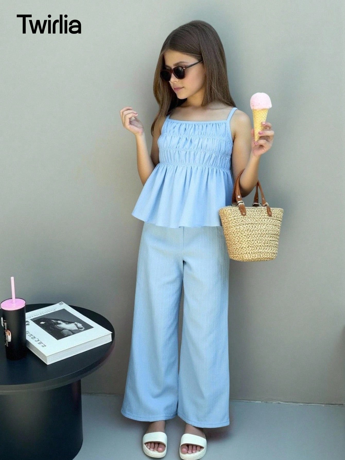 Tween girl wearing an apricot 2-piece outfit set featuring a shirred spaghetti strap short cami top and matching wide-leg long pants.
