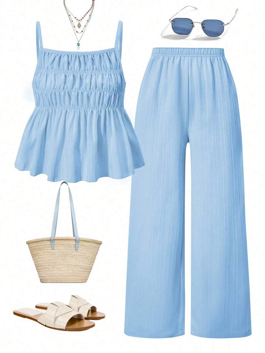 Tween girl wearing an apricot 2-piece outfit set featuring a shirred spaghetti strap short cami top and matching wide-leg long pants.
