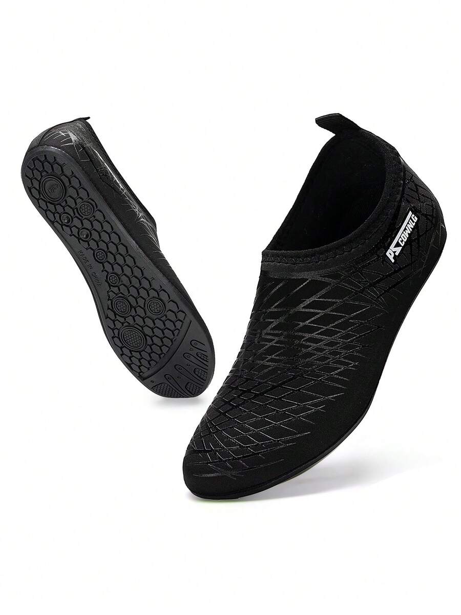 Black slip-on kids water shoes with a graphic pattern fabric upper and wear-resistant rubber outsole for boys and girls.