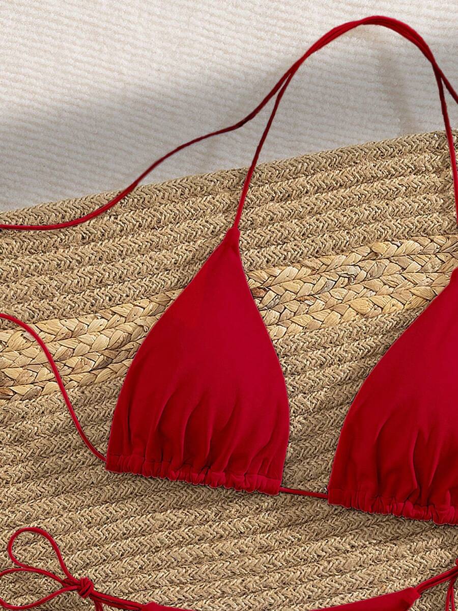 Women's 2-piece bikini set featuring a backless halter triangle top and tie-side ultra low waist bottoms.