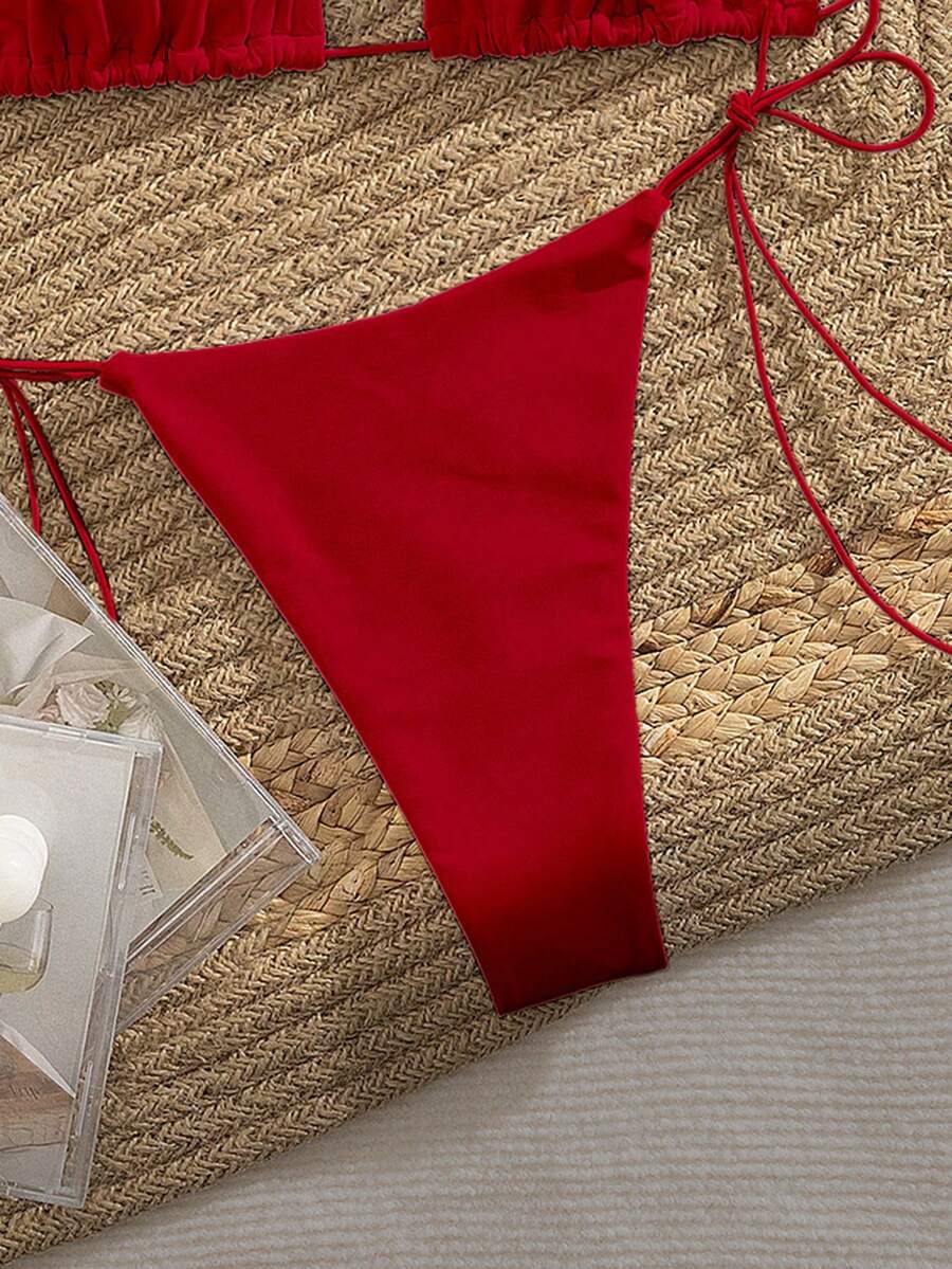 Women's 2-piece bikini set featuring a backless halter triangle top and tie-side ultra low waist bottoms.