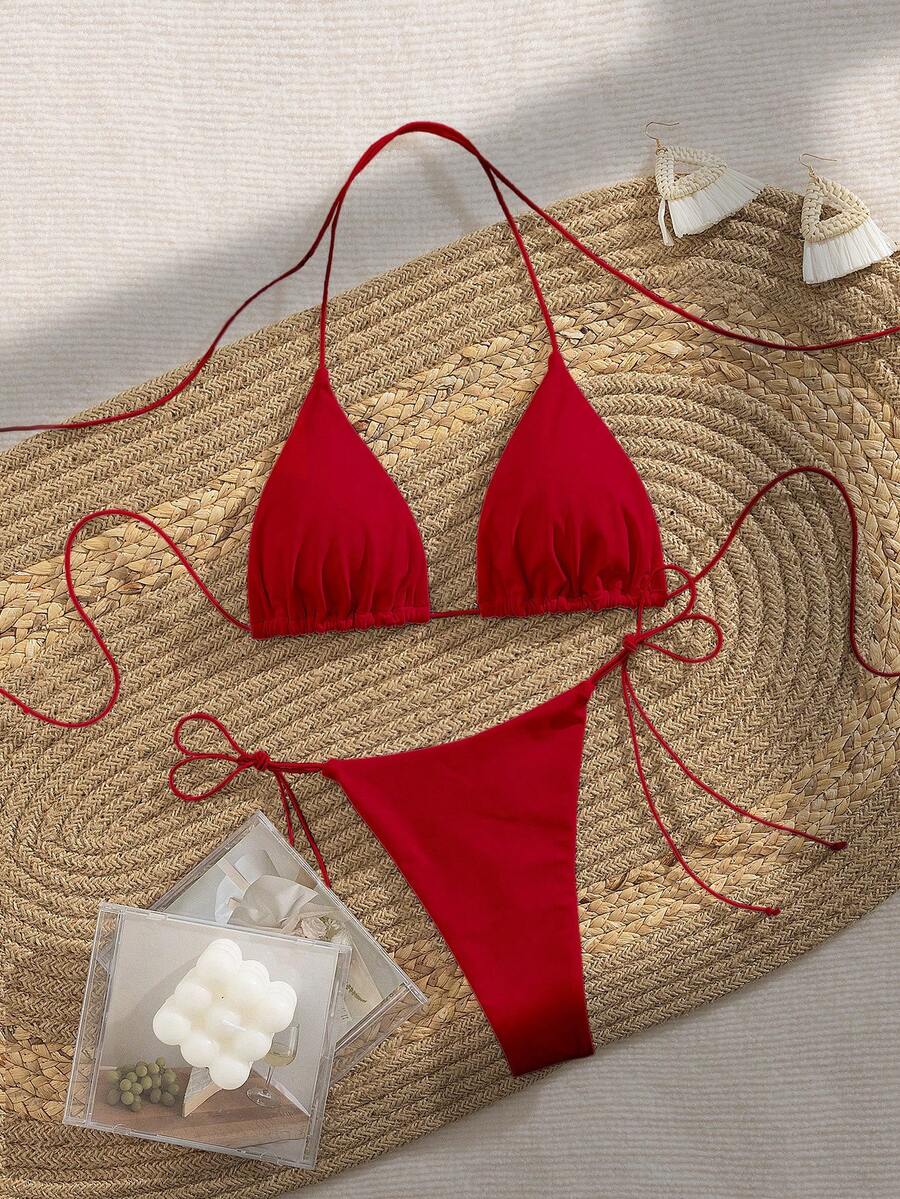 Women's 2-piece bikini set featuring a backless halter triangle top and tie-side ultra low waist bottoms.