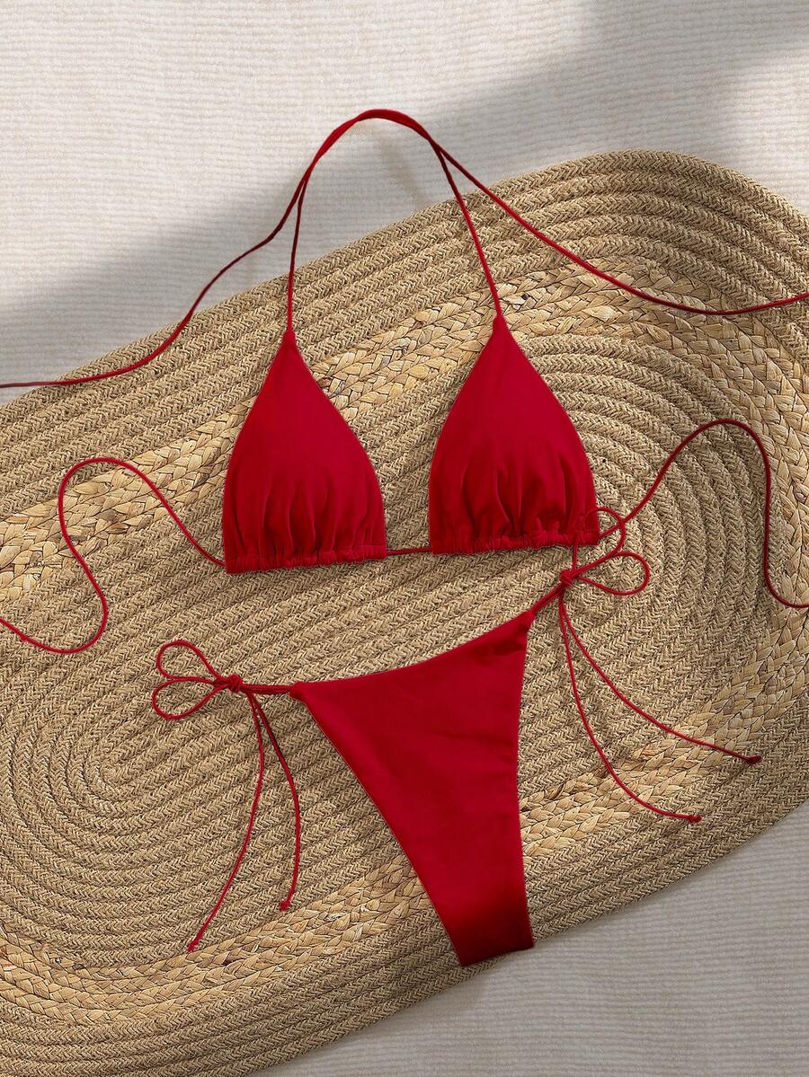 Women's 2-piece bikini set featuring a backless halter triangle top and tie-side ultra low waist bottoms.
