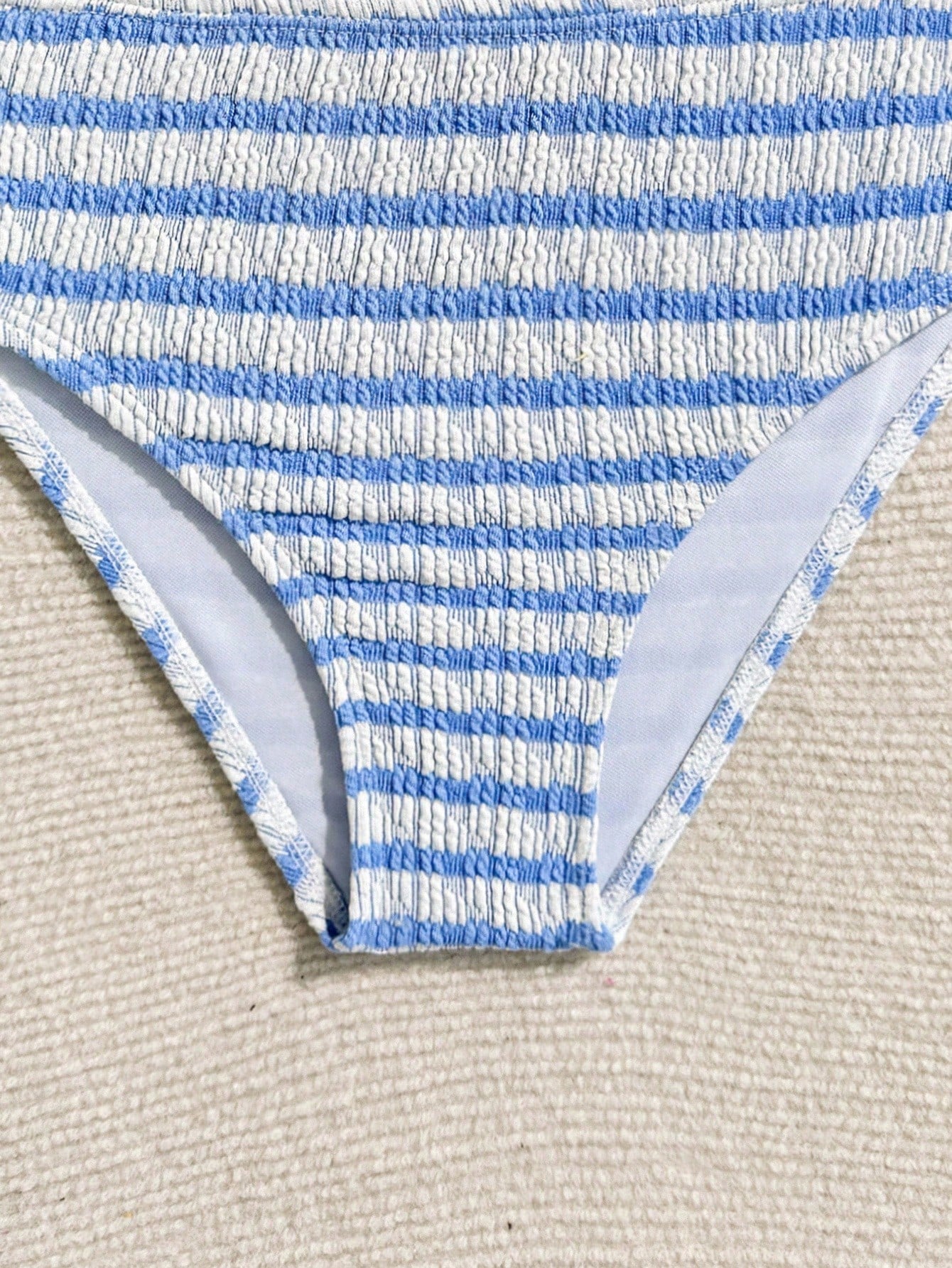 Tween girls blue and white striped two-piece bikini set with halter triangle top and mid-waist short bikini bottoms for beach and vacation swimwear.