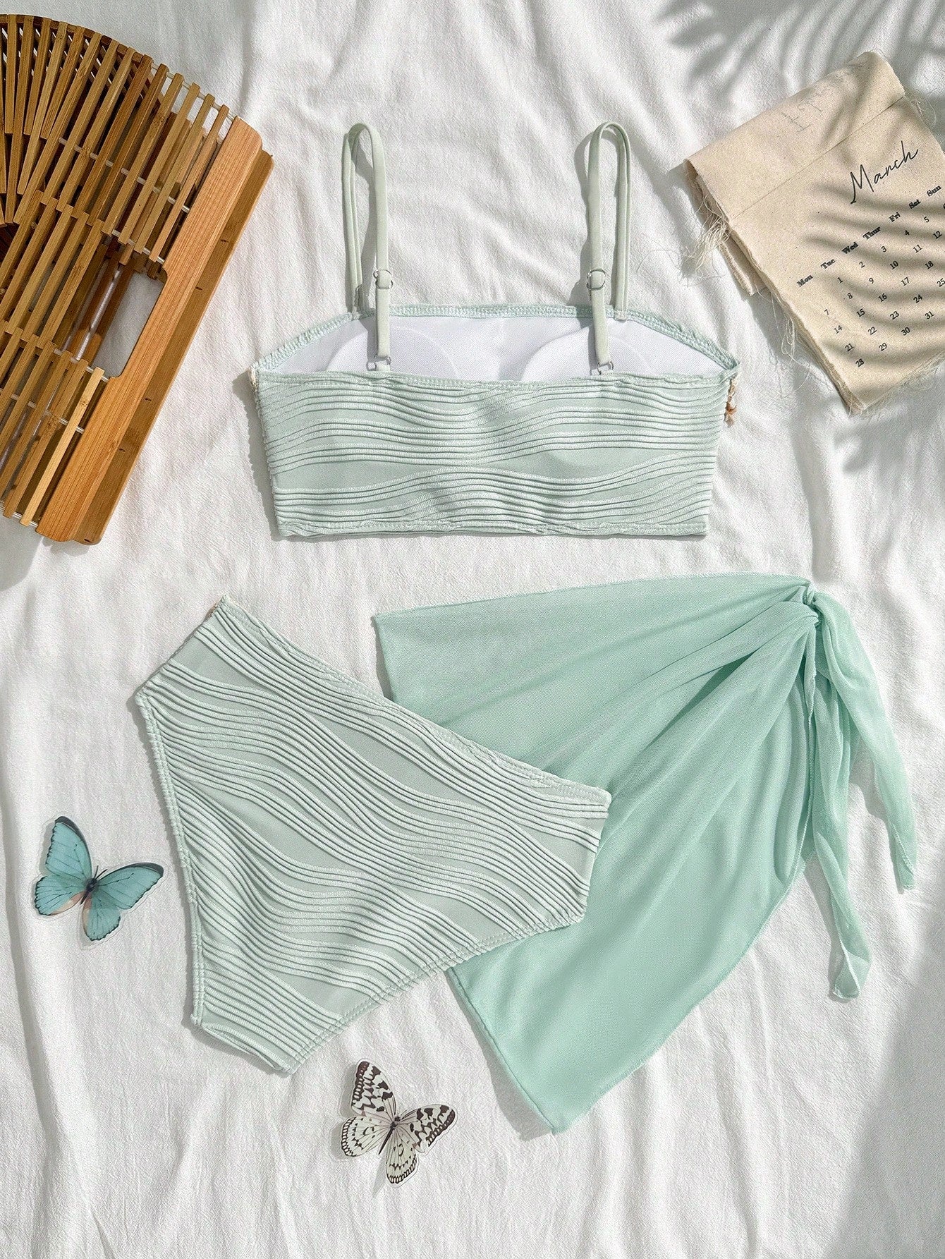 Tween girls bikini set with shell and starfish woven band details, spaghetti strap sleeveless top, and mid-waist skirt-style bottom in blue.