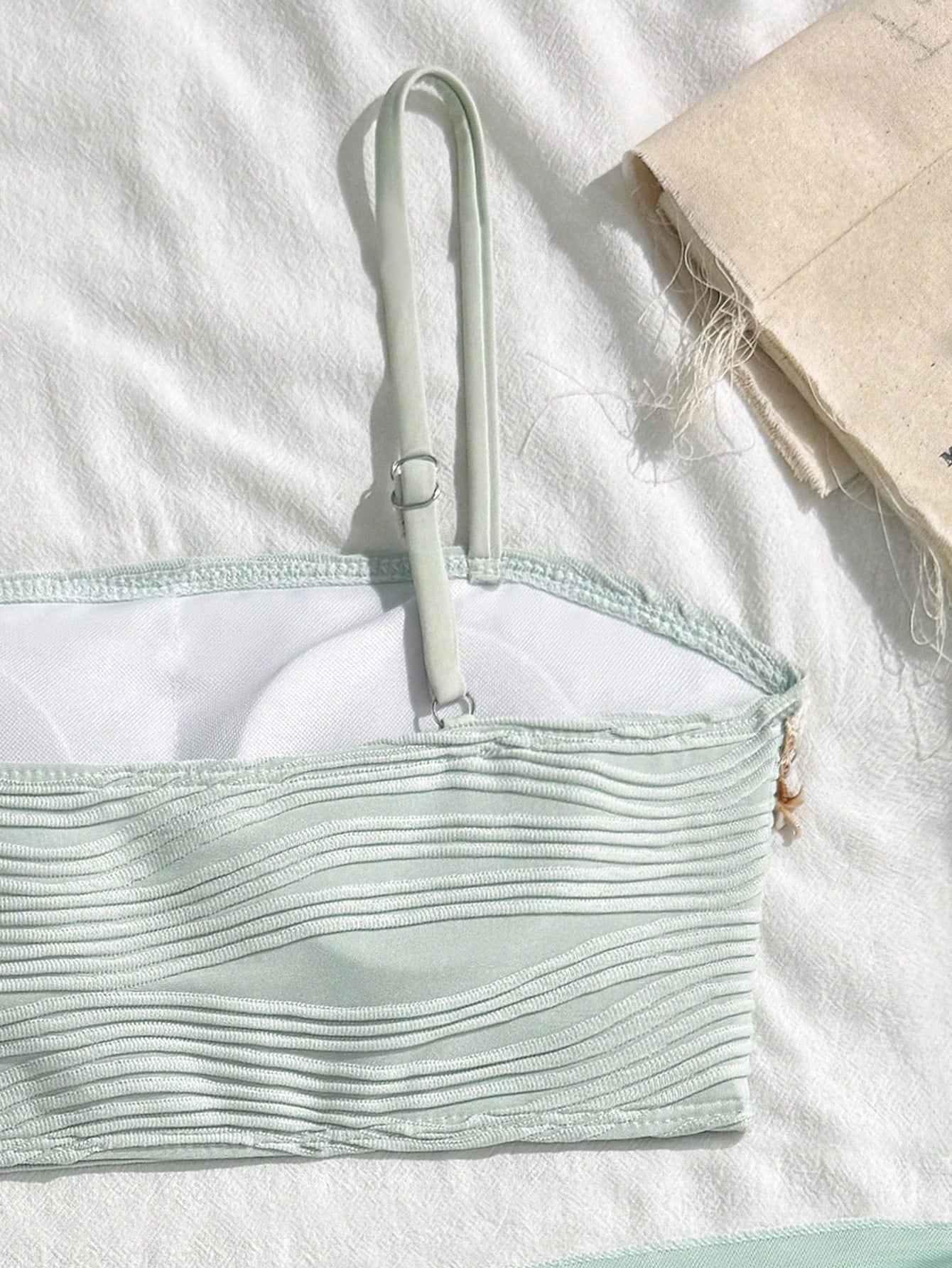 Tween girls bikini set with shell and starfish woven band details, spaghetti strap sleeveless top, and mid-waist skirt-style bottom in blue.