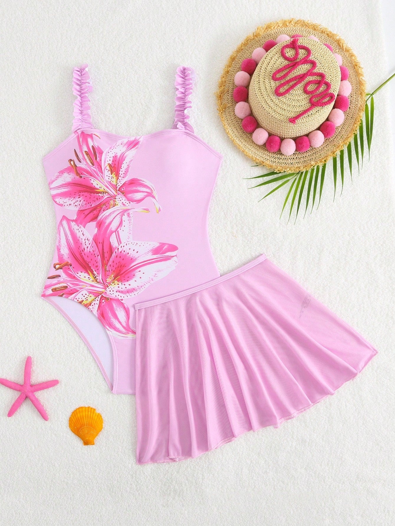 Girls floral print swimsuit set with strap neckline, sleeveless fitted top, and pleated mesh skirt bottom for beach and summer vacation wear.