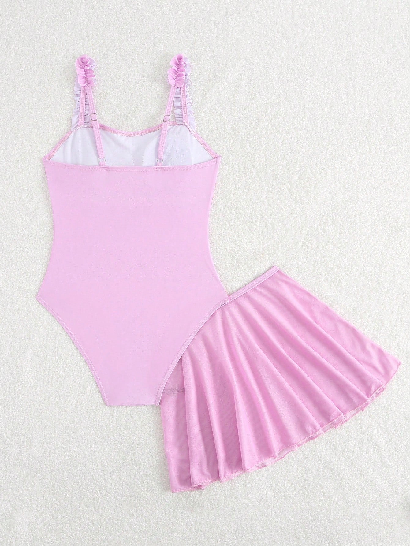 Girls floral print swimsuit set with strap neckline, sleeveless fitted top, and pleated mesh skirt bottom for beach and summer vacation wear.