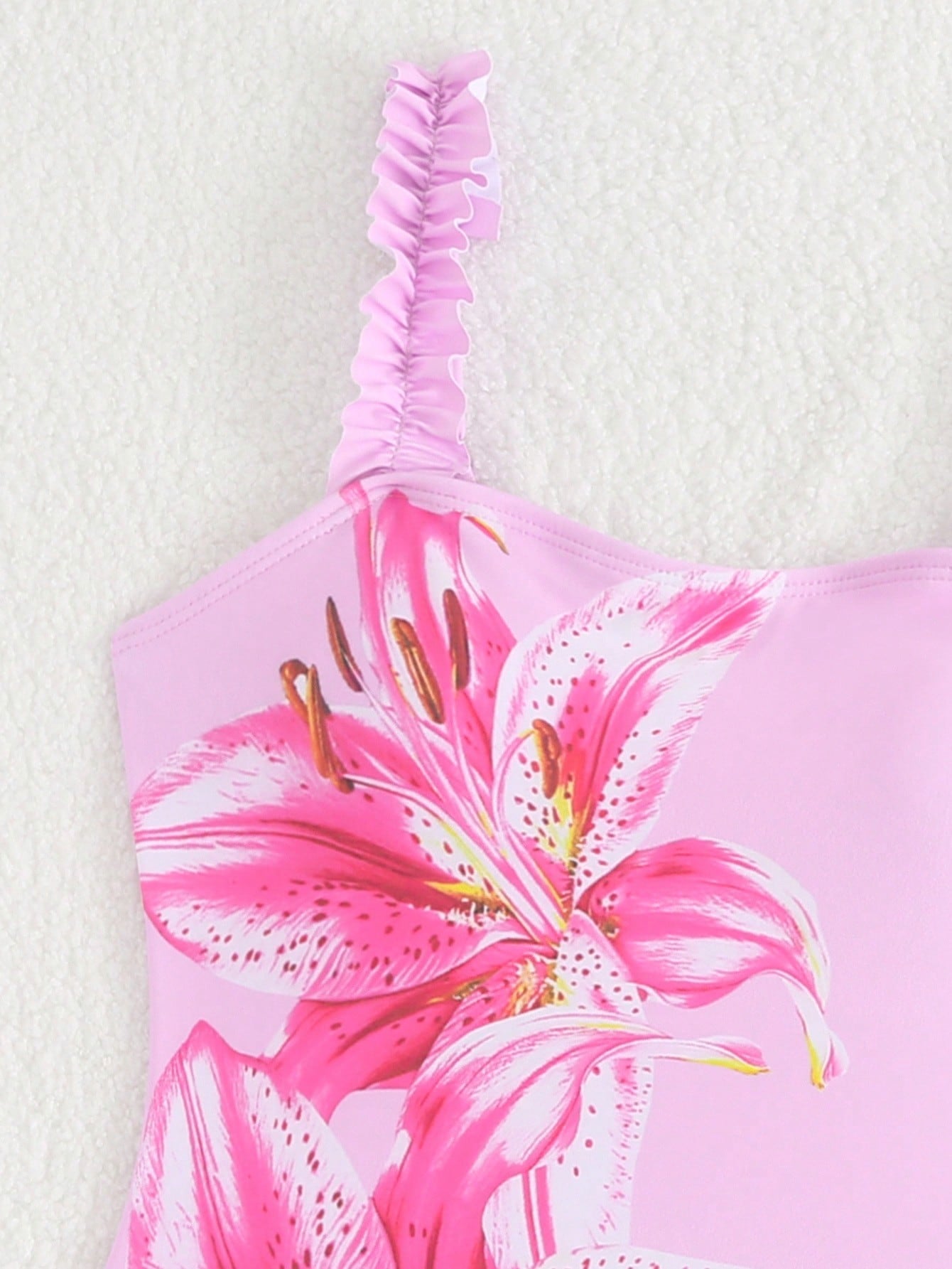 Girls floral print swimsuit set with strap neckline, sleeveless fitted top, and pleated mesh skirt bottom for beach and summer vacation wear.