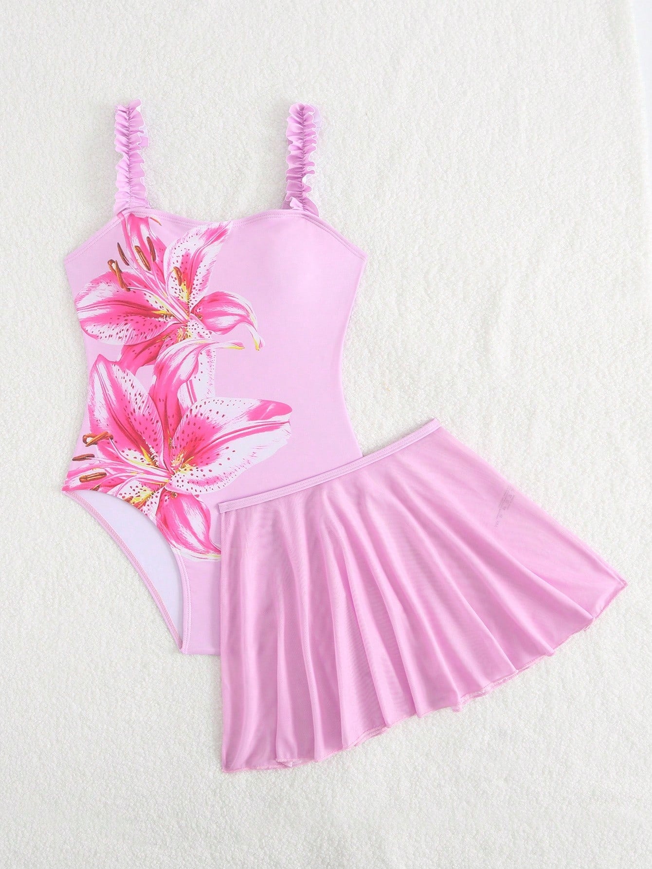 Girls floral print swimsuit set with strap neckline, sleeveless fitted top, and pleated mesh skirt bottom for beach and summer vacation wear.