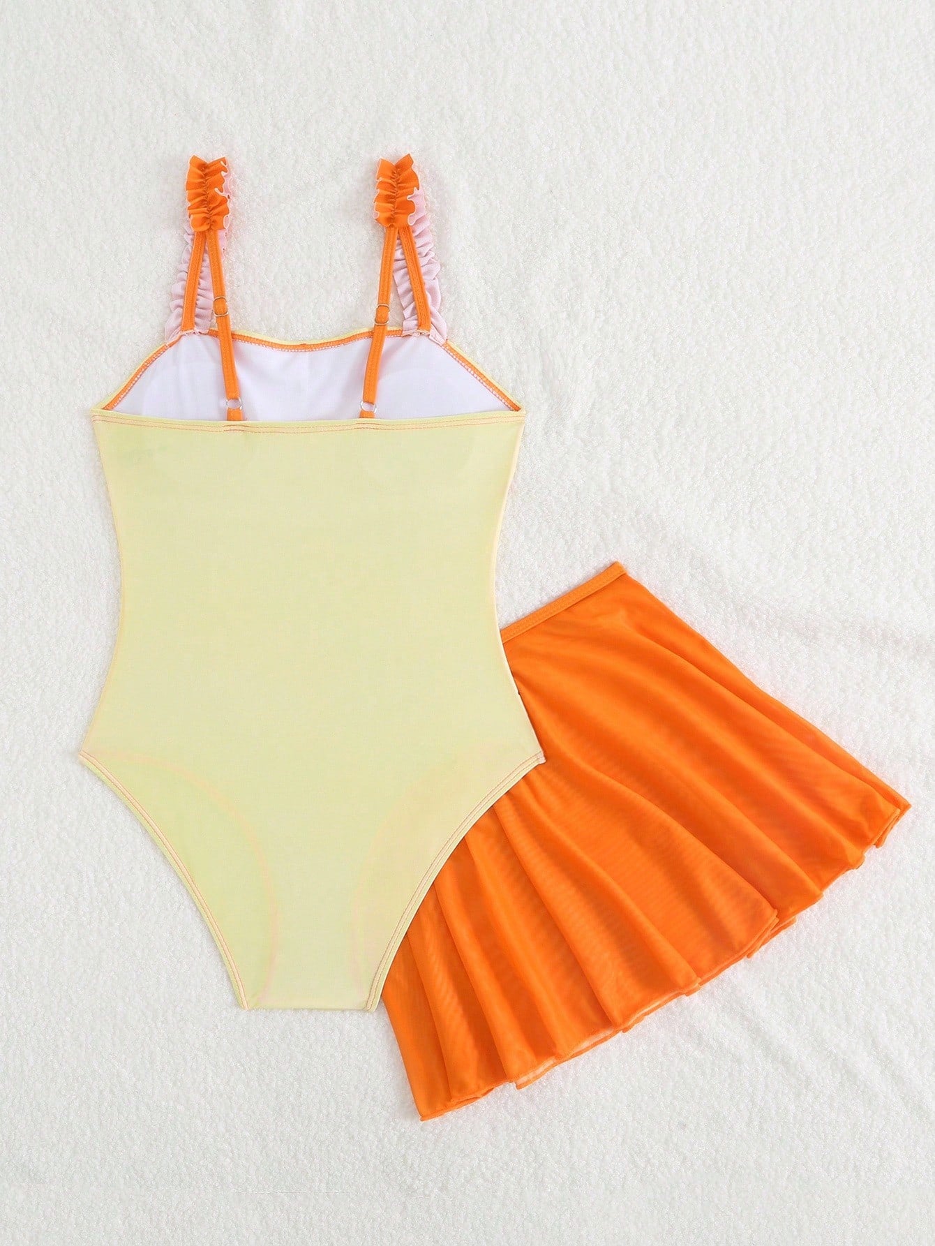 Girls floral print swimsuit set with strap neckline, sleeveless fitted top, and pleated mesh skirt bottom for beach and summer vacation wear.