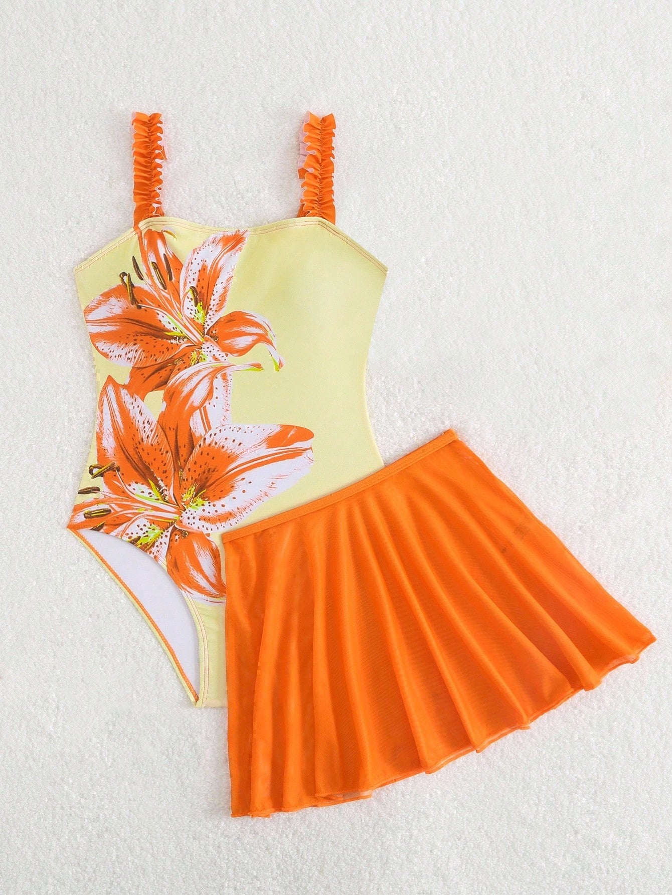 Girls floral print swimsuit set with strap neckline, sleeveless fitted top, and pleated mesh skirt bottom for beach and summer vacation wear.