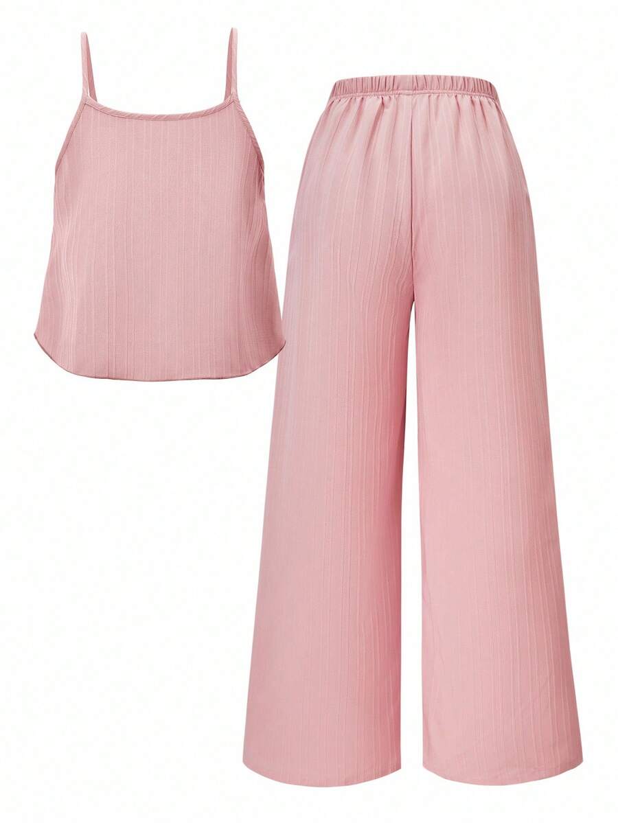 Tween girl wearing an apricot 2-piece outfit set featuring a shirred spaghetti strap short cami top and matching wide-leg long pants.