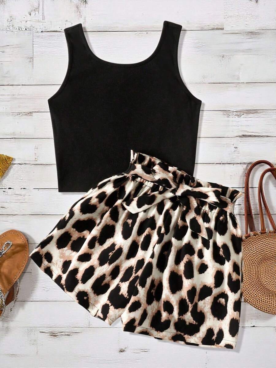 Tween girl wearing a casual 2-piece set featuring a black rib-knit scoop neck tank top and leopard print paperbag waist shorts with a matching belt.