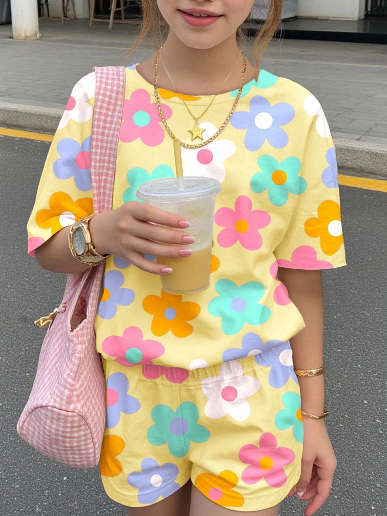Tween girls multicolor tie-dye 2-piece outfit set featuring a drop-shoulder short-sleeve t-shirt and matching loose track shorts with side pockets.