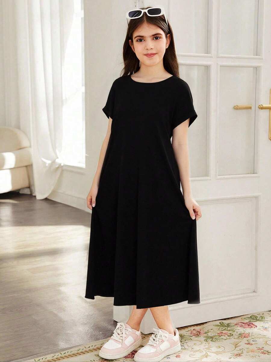Tween girls casual black A-line long dress featuring short sleeves, a round neckline, and a decorative front bow with contrast lace trim.