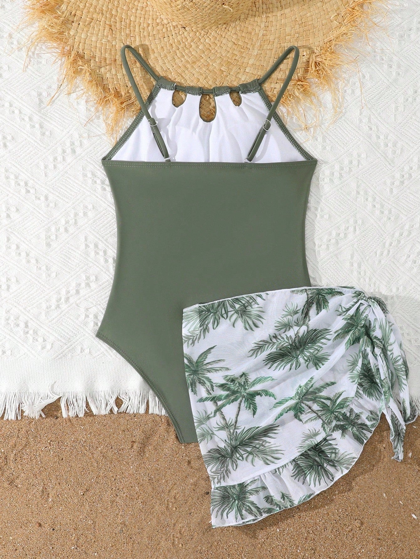 Girls black and white one-piece swimsuit set with cut-out detail, spaghetti straps, sleeveless fitted design, and matching skirt bottom for vacation swimwear.