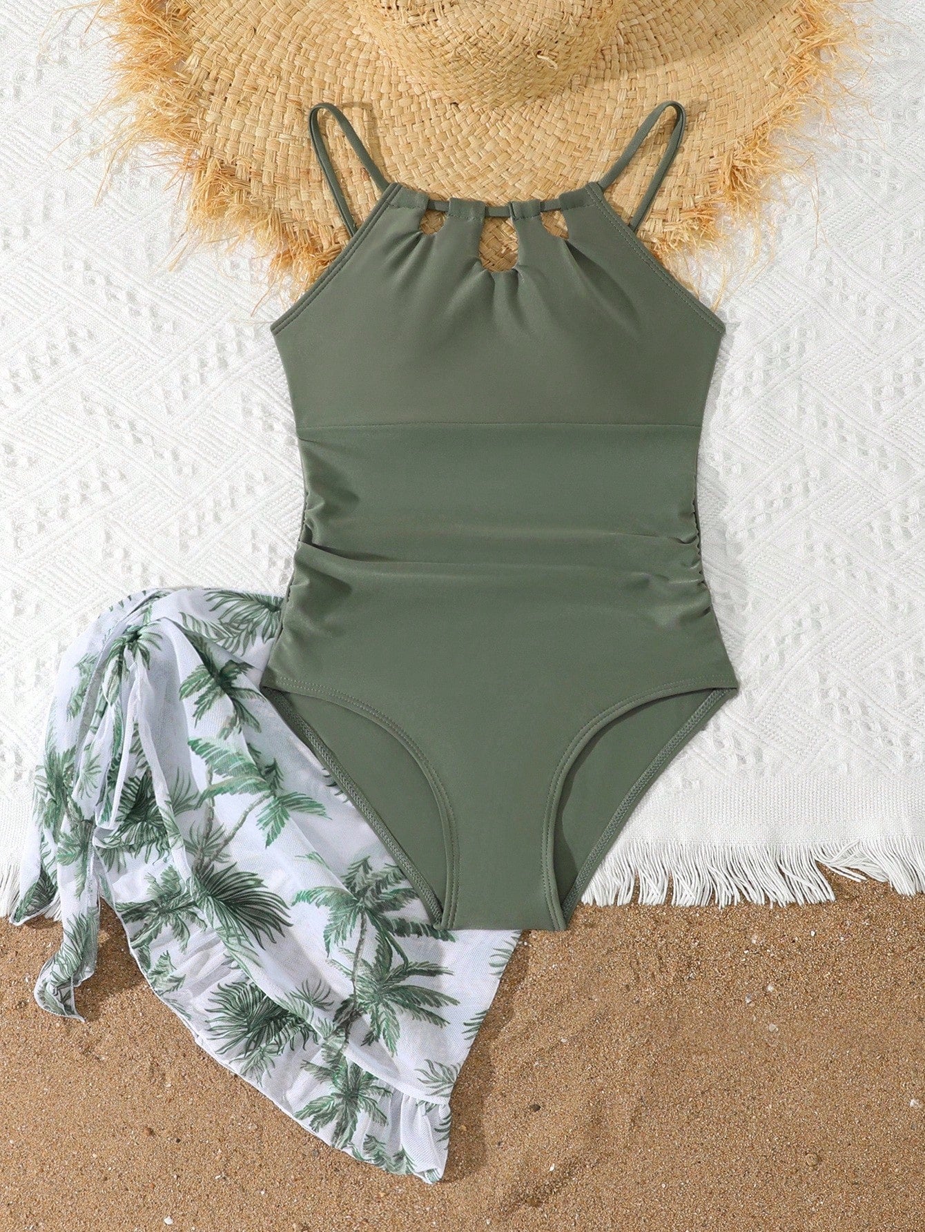Girls black and white one-piece swimsuit set with cut-out detail, spaghetti straps, sleeveless fitted design, and matching skirt bottom for vacation swimwear.