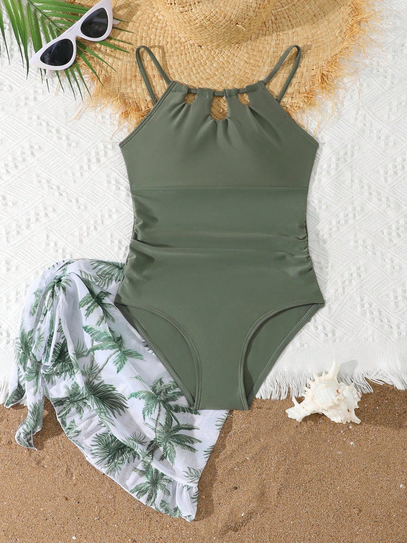 Girls black and white one-piece swimsuit set with cut-out detail, spaghetti straps, sleeveless fitted design, and matching skirt bottom for vacation swimwear.