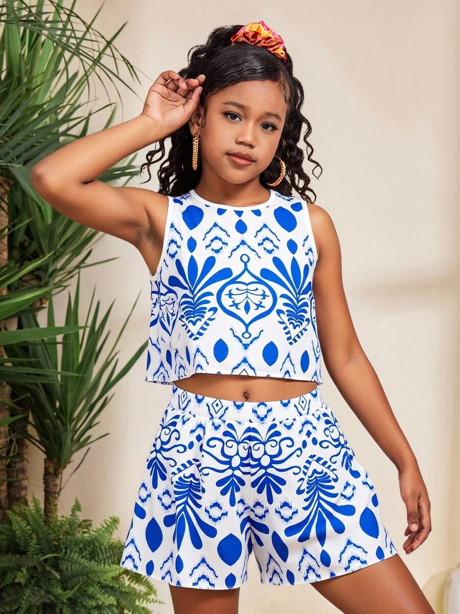 Tween girl wearing a tropical floral print two-piece vacation set featuring a sleeveless round neck tank top with button details and matching shorts.