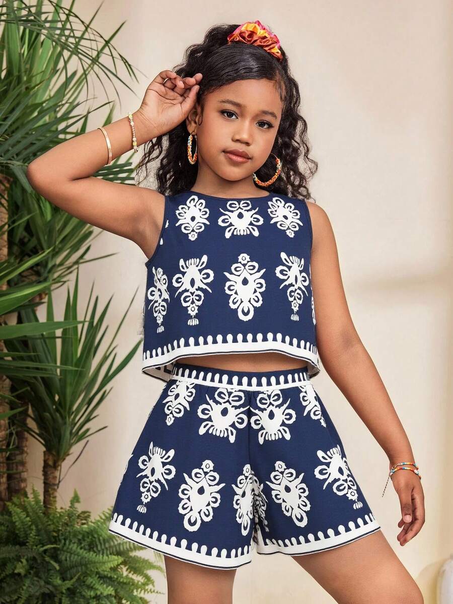 Tween girl wearing a tropical floral print two-piece vacation set featuring a sleeveless round neck tank top with button details and matching shorts.
