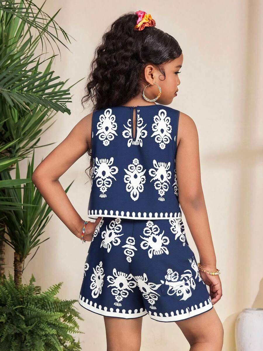Tween girl wearing a tropical floral print two-piece vacation set featuring a sleeveless round neck tank top with button details and matching shorts.