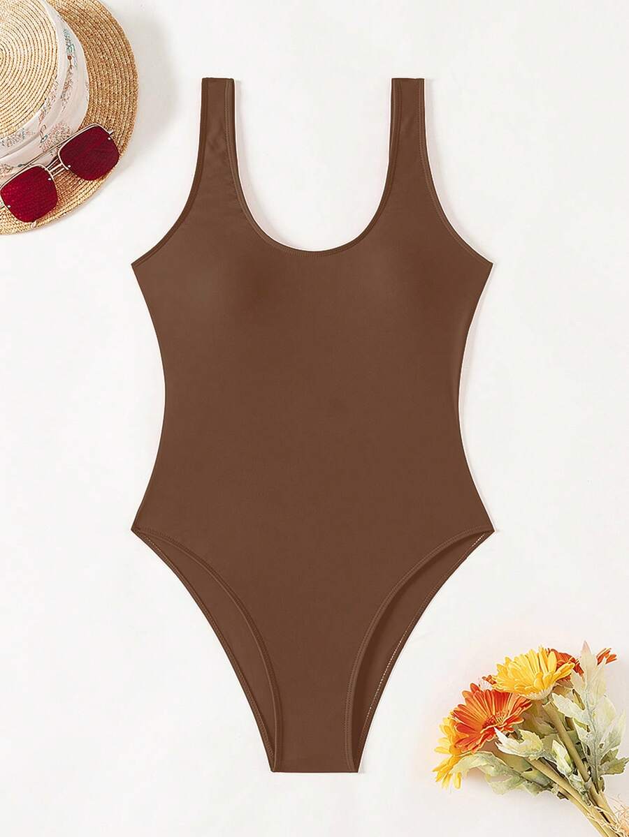 Women's solid color one-piece swimsuit featuring a backless scoop neck design and high cut fit