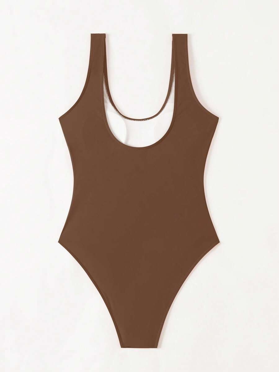 Women's solid color one-piece swimsuit featuring a backless scoop neck design and high cut fit