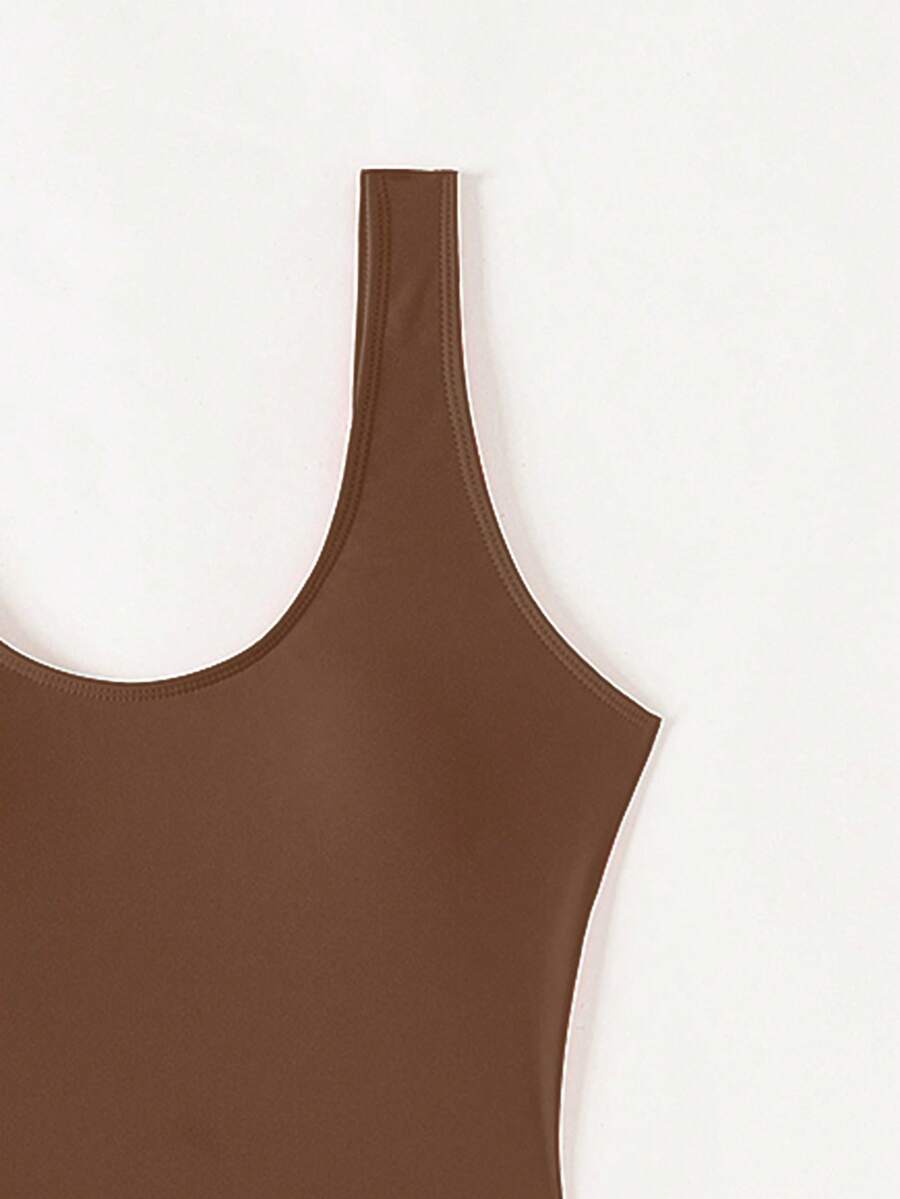 Women's solid color one-piece swimsuit featuring a backless scoop neck design and high cut fit