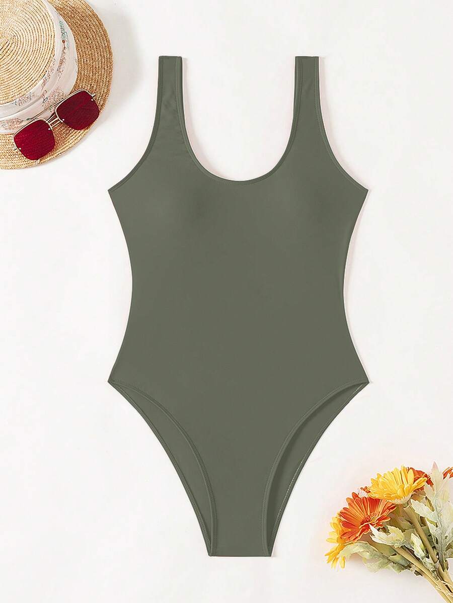 Women's solid color one-piece swimsuit featuring a backless scoop neck design and high cut fit