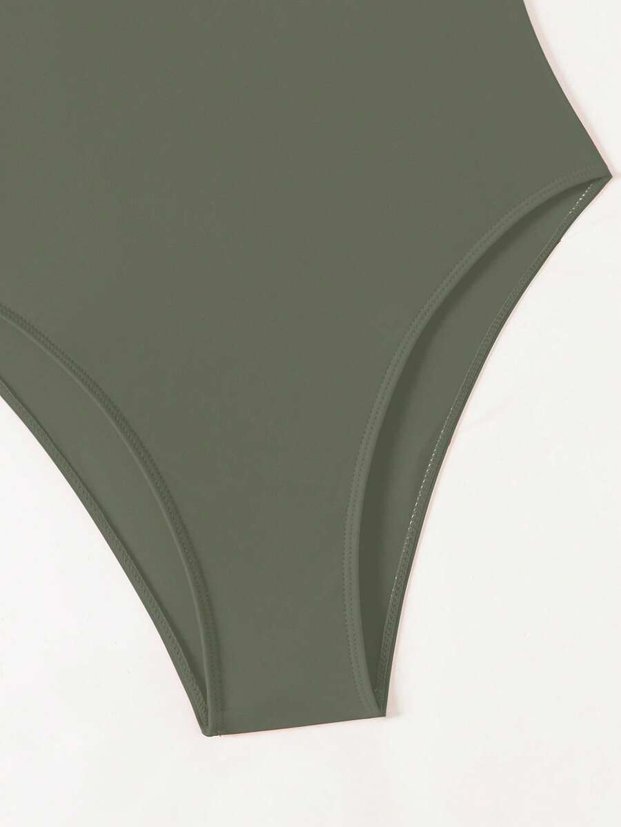 Women's solid color one-piece swimsuit featuring a backless scoop neck design and high cut fit