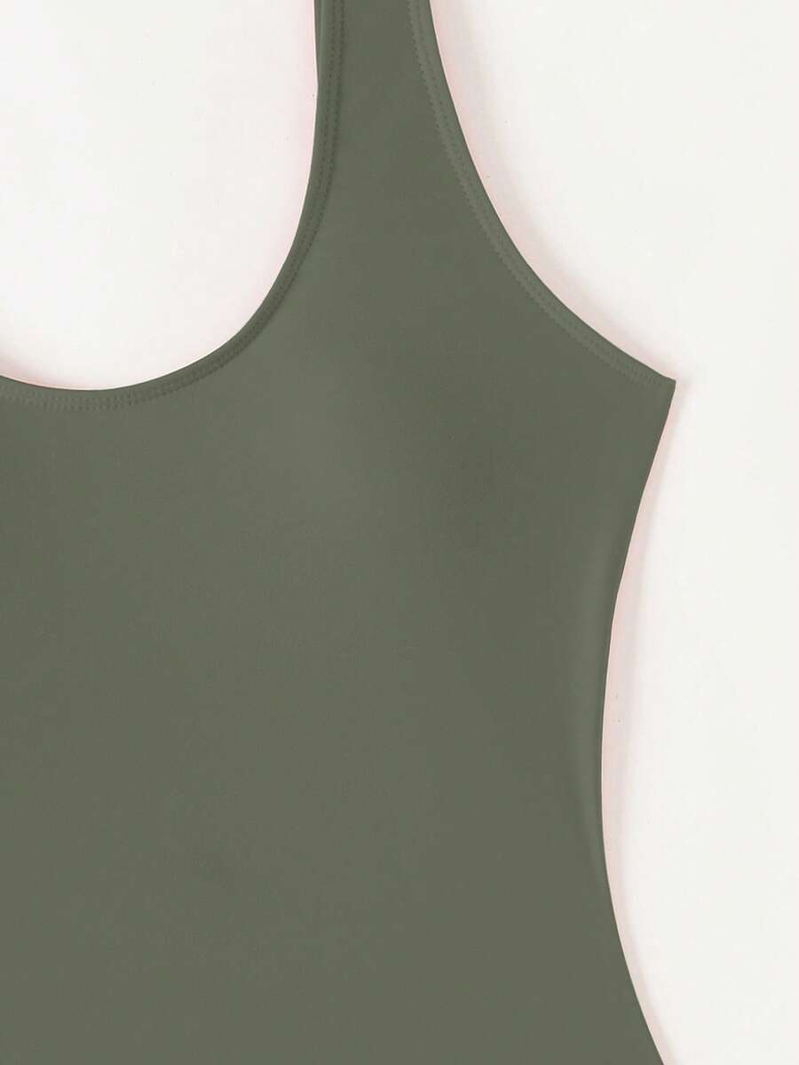 Women's solid color one-piece swimsuit featuring a backless scoop neck design and high cut fit