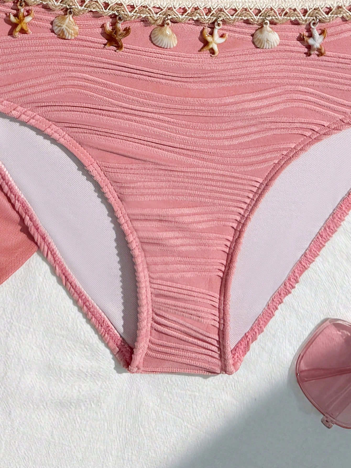 Tween girls bikini set with shell and starfish woven band details, spaghetti strap sleeveless top, and mid-waist skirt-style bottom in blue.