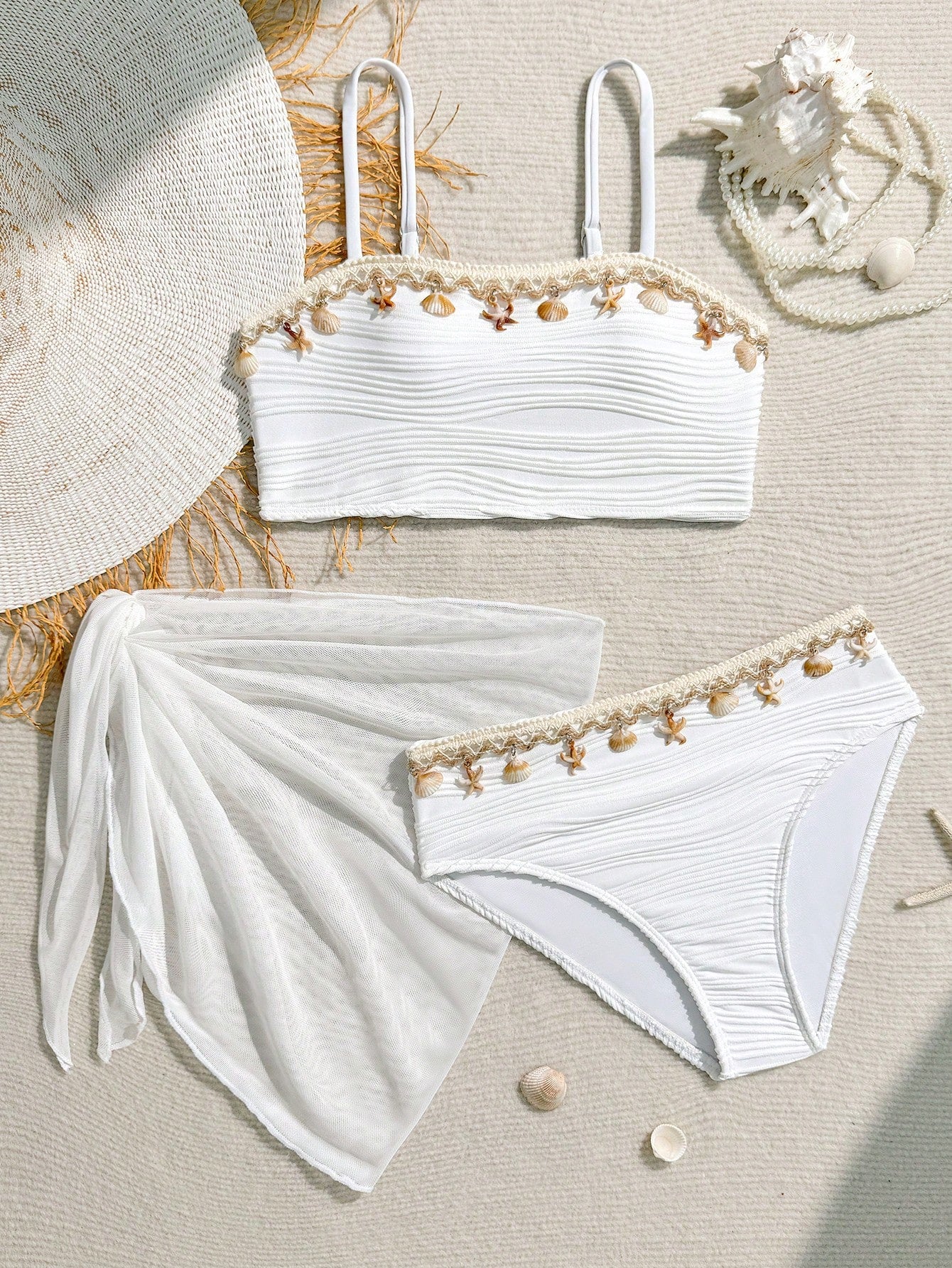 Tween girls bikini set with shell and starfish woven band details, spaghetti strap sleeveless top, and mid-waist skirt-style bottom in blue.