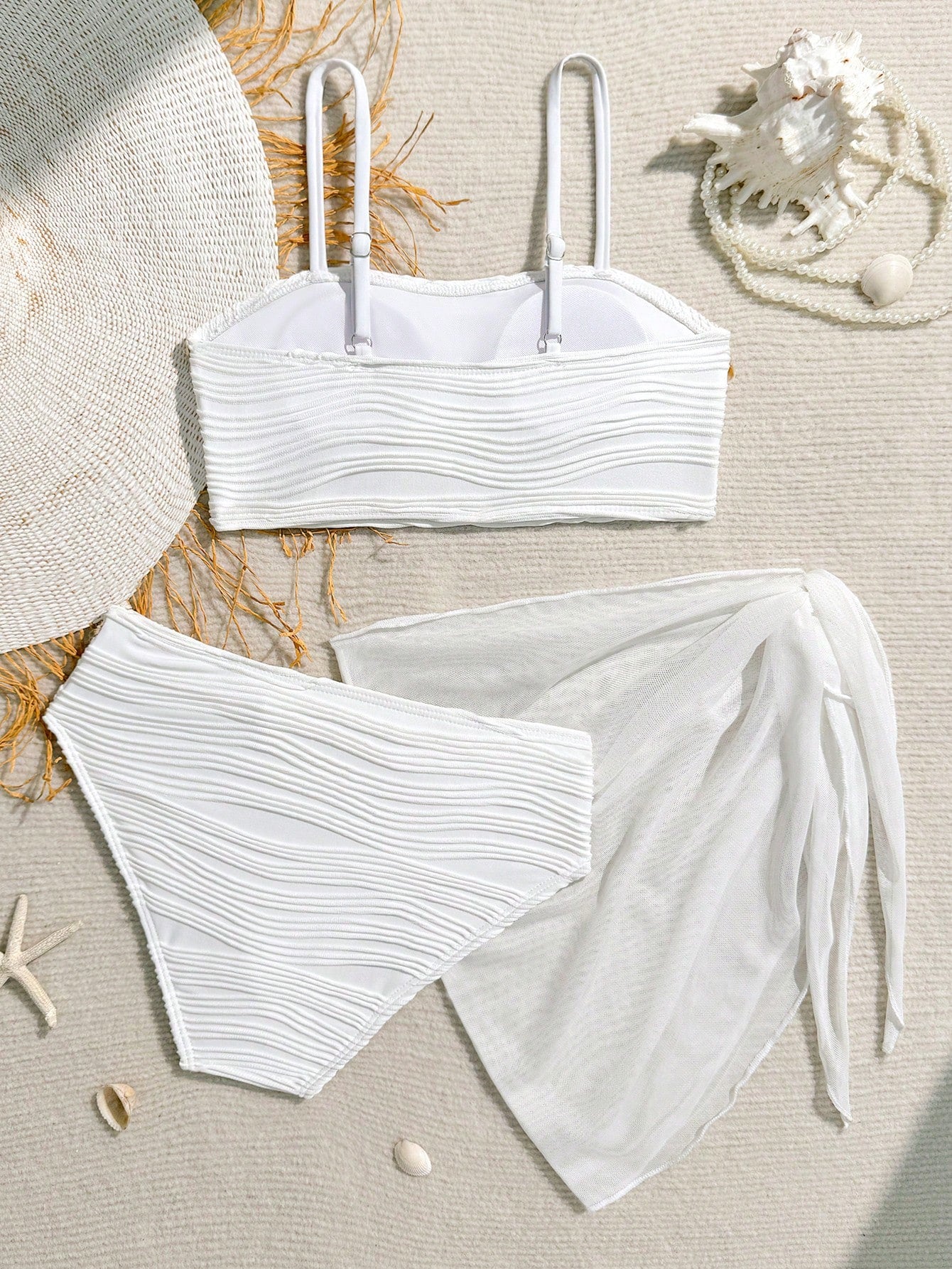Tween girls bikini set with shell and starfish woven band details, spaghetti strap sleeveless top, and mid-waist skirt-style bottom in blue.
