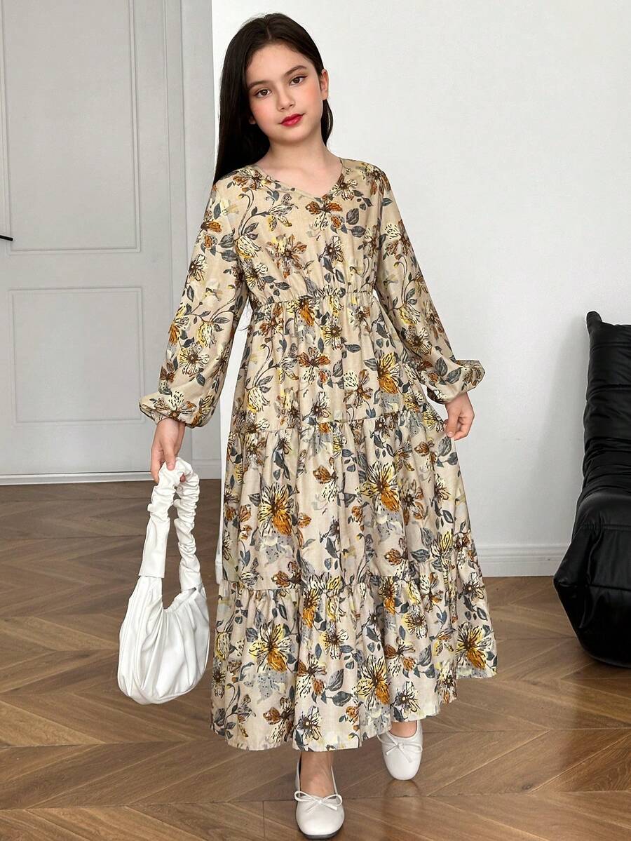 Tween girl wearing an apricot ditsy floral V-neck midi dress with long bishop puff sleeves, tiered ruffle layers, and a flounce hem.