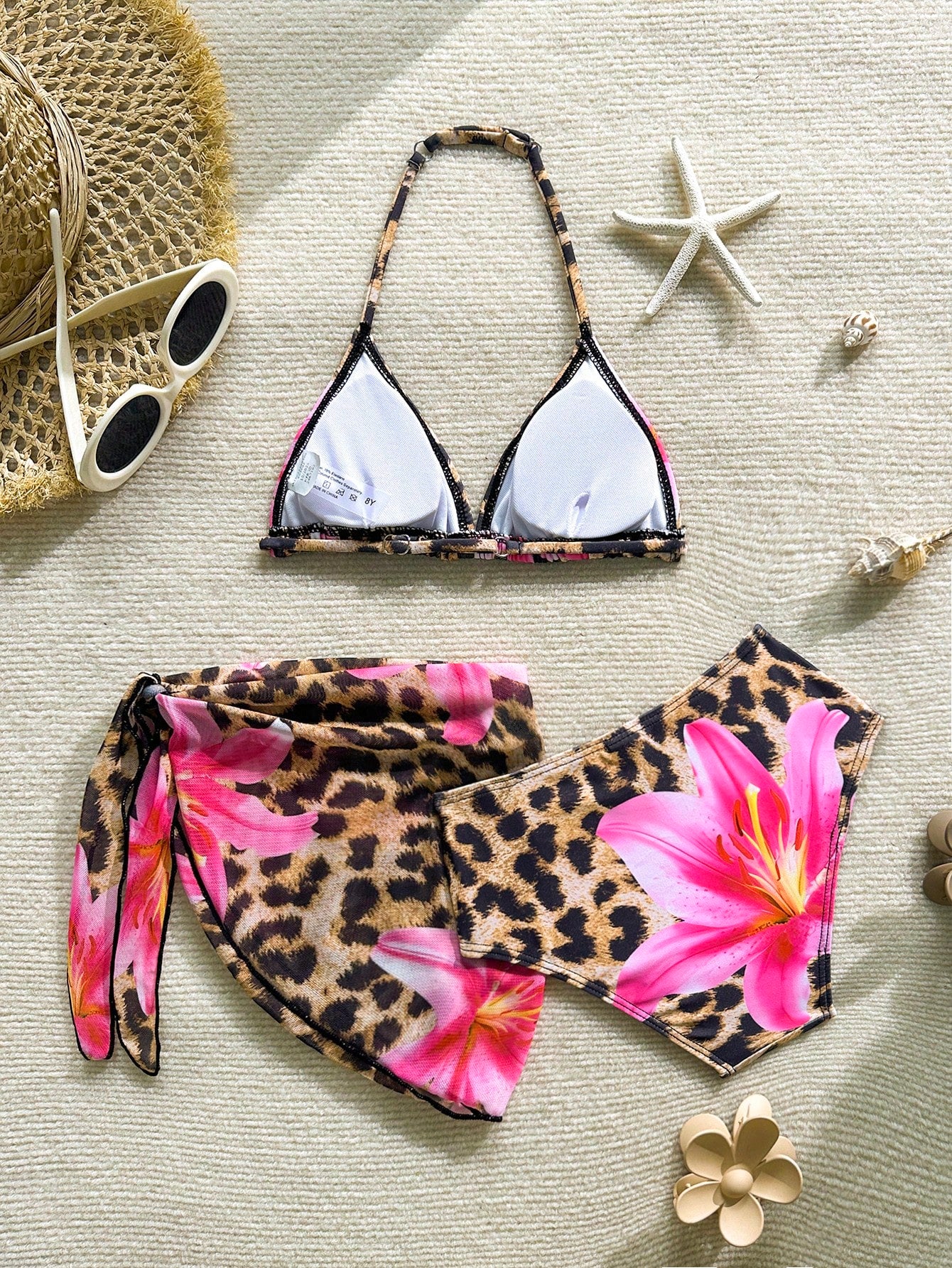 Tween girls 3-piece swimwear set in pink featuring a striped triangle halter bikini top with bow detail and adjustable neck and back ties, an adjustable mid-waist bikini bottom, and a sheer pink mesh skirt cover-up for beach or pool wear.