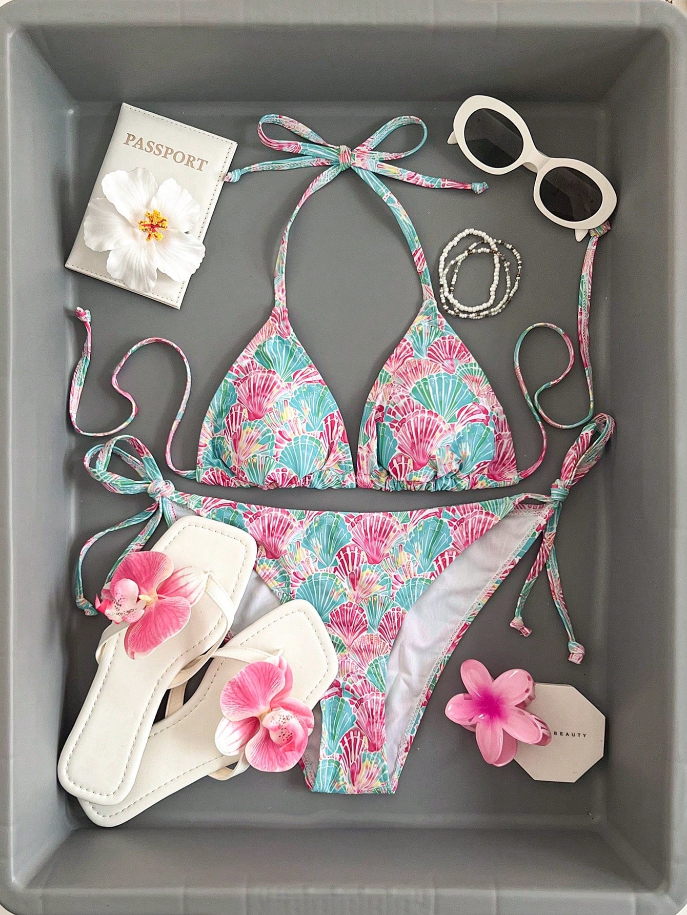 Women's black and white zebra print two-piece bikini set featuring a high waist tie-side bottom and a backless halter top with removable padding.