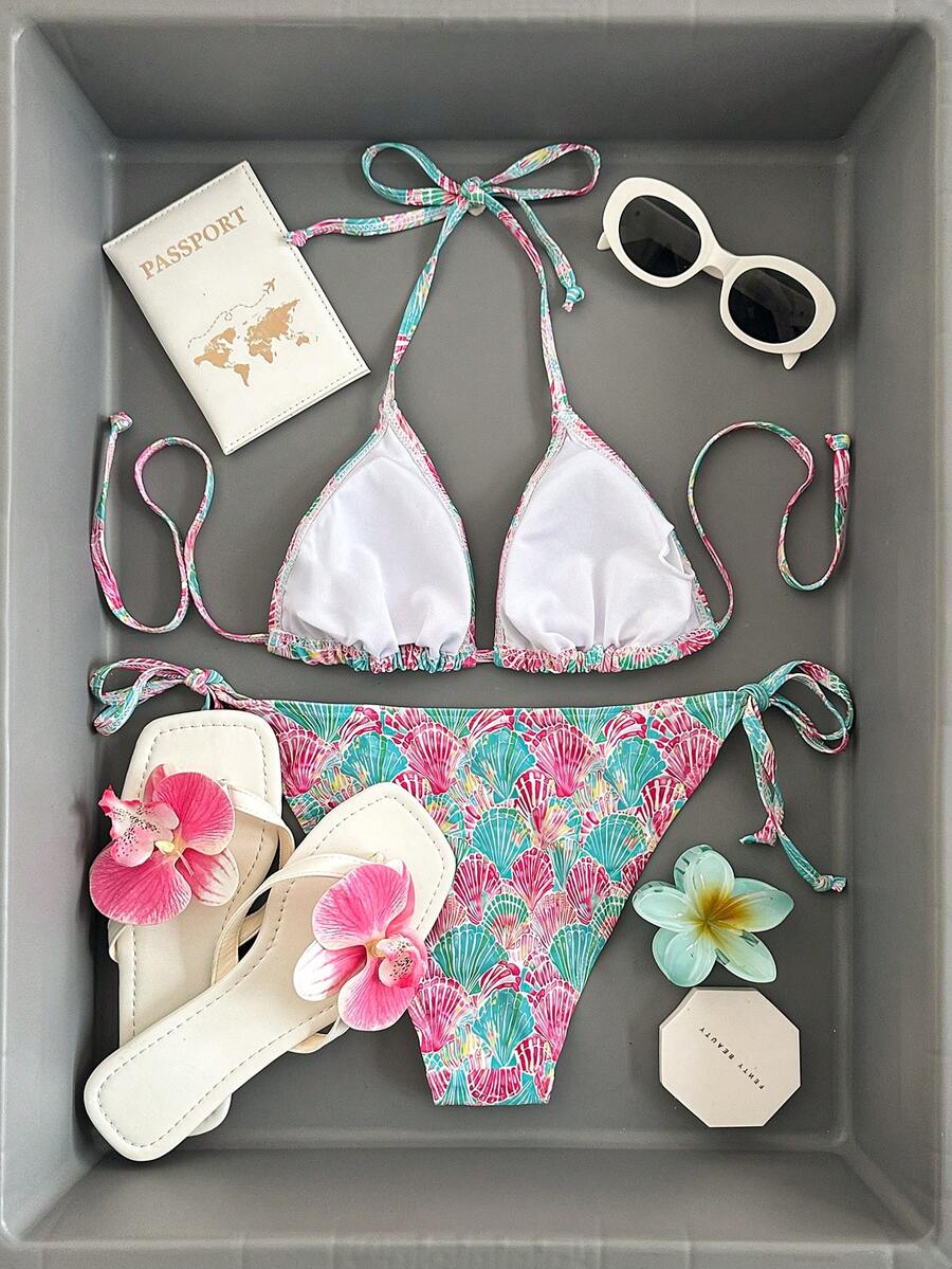 Women's black and white zebra print two-piece bikini set featuring a high waist tie-side bottom and a backless halter top with removable padding.