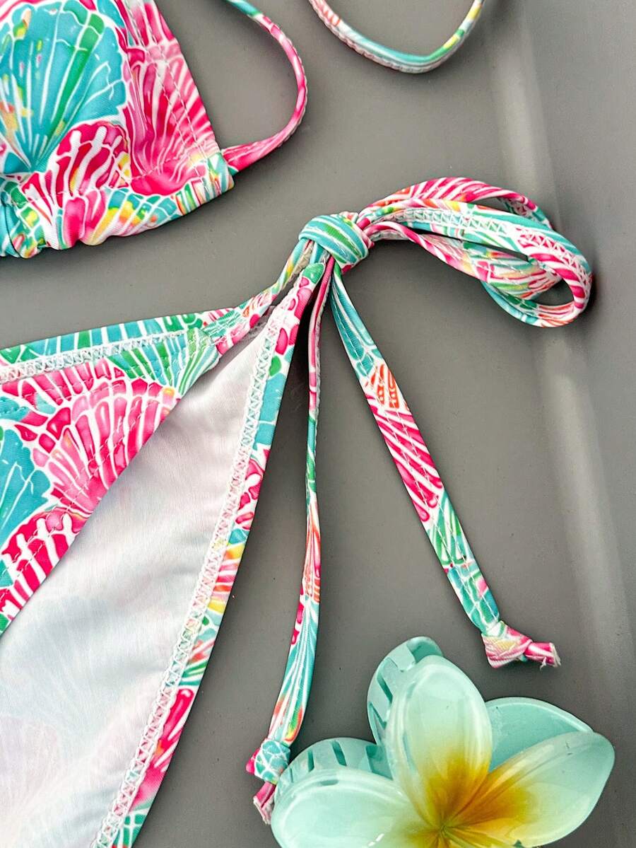 Women's black and white zebra print two-piece bikini set featuring a high waist tie-side bottom and a backless halter top with removable padding.