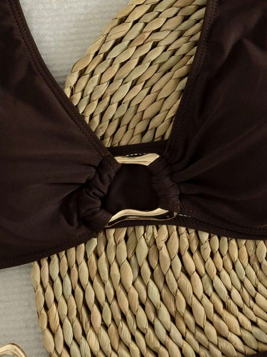 Women's 2-piece solid color halter bikini set featuring a backless tie-back wireless top and mid-waist swimsuit bottoms.