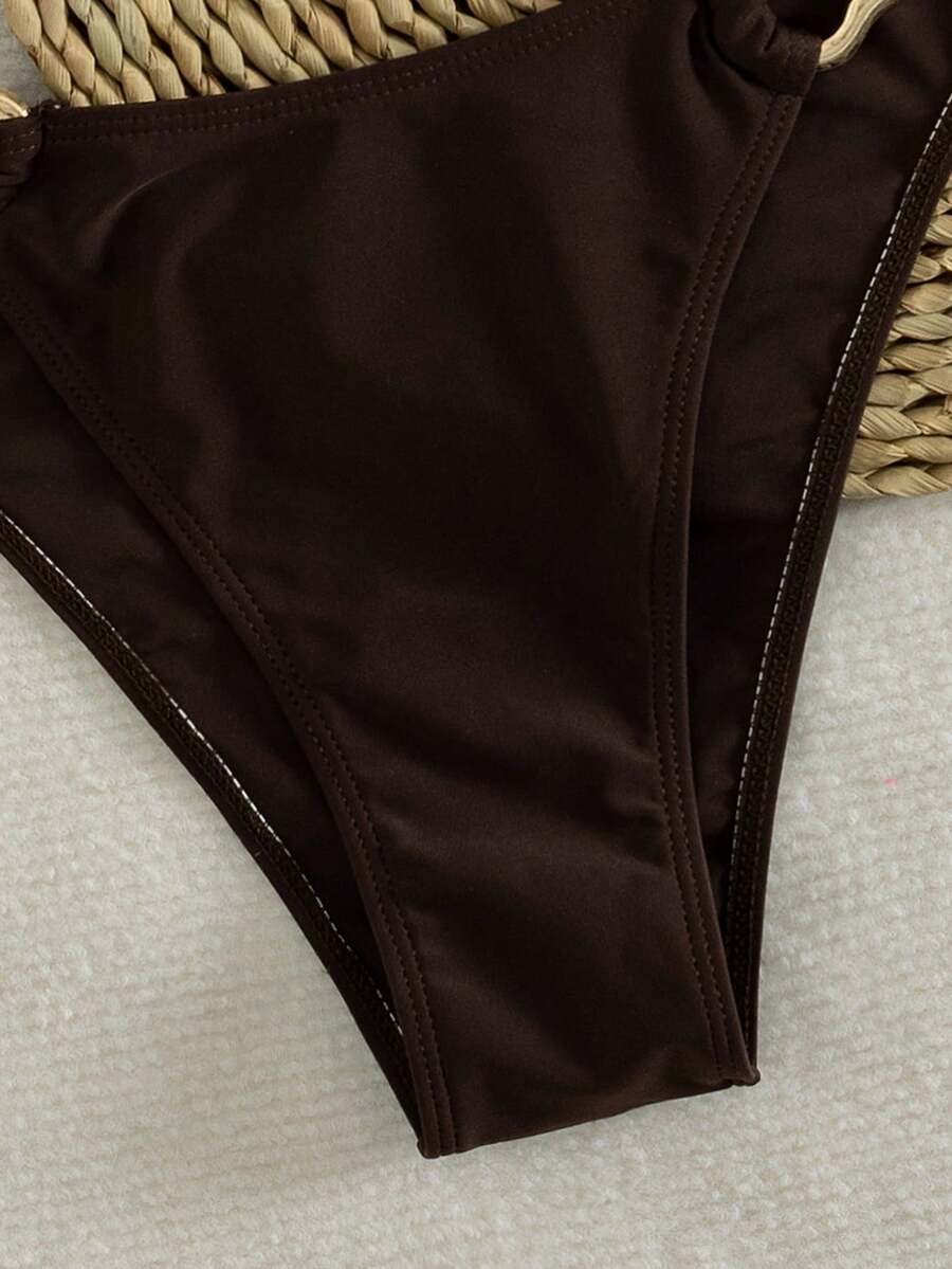 Women's 2-piece solid color halter bikini set featuring a backless tie-back wireless top and mid-waist swimsuit bottoms.