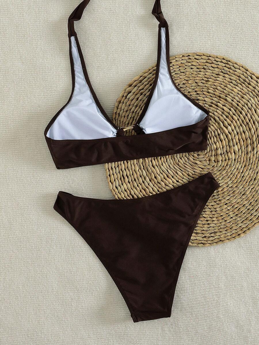 Women's 2-piece solid color halter bikini set featuring a backless tie-back wireless top and mid-waist swimsuit bottoms.